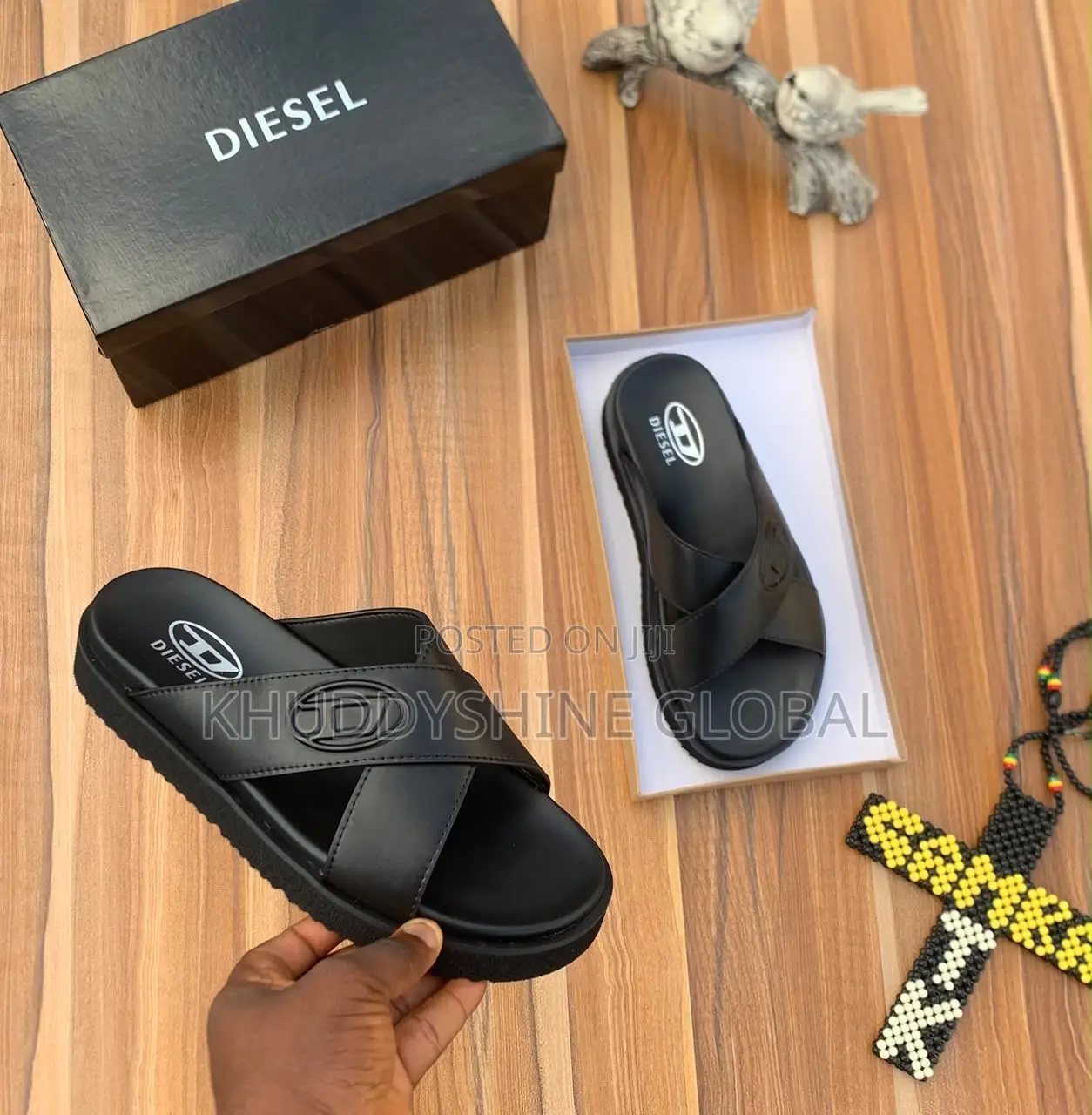 Men's Designer-Style Slip-on Sandals and Slides Arranged on a Wooden
