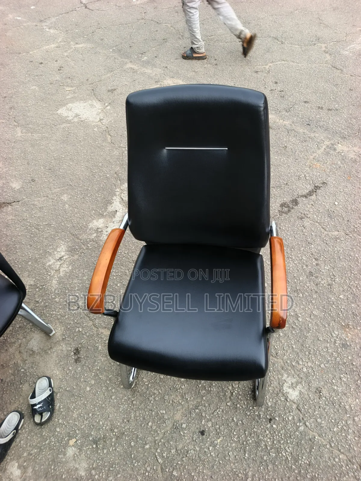 Black Leather Visitor Office Chair Featuring Polished Wooden Armrests.
