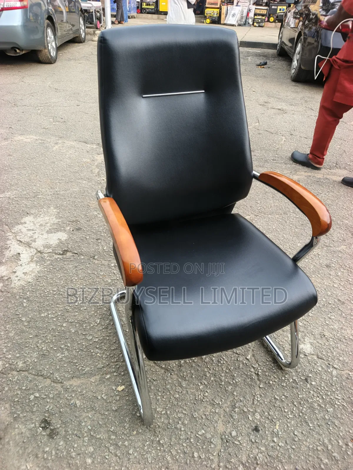 Black Leather Visitor Office Chair Featuring Polished Wooden Armrests.