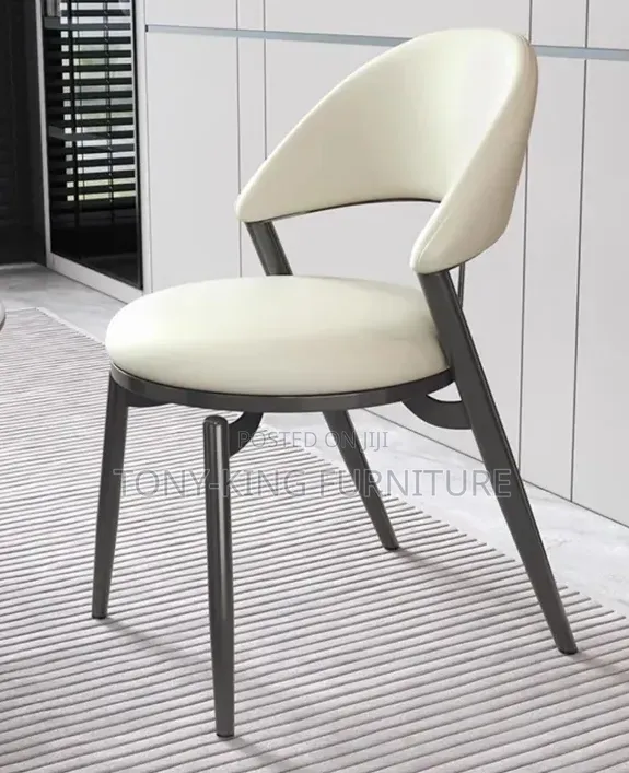 Century Modern Dining Chair Featuring a Cream Faux-Leather Chair