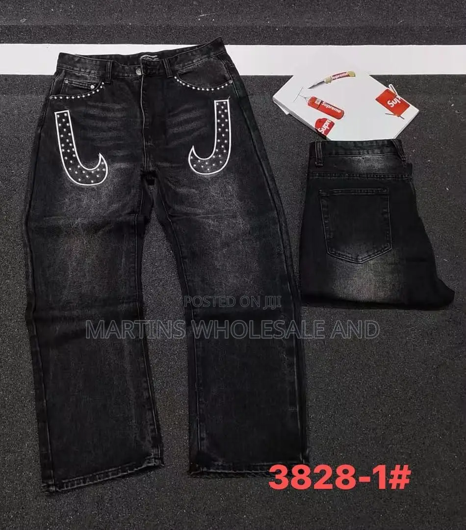 Black Washed Denim Jeans Featuring Paneled Knee Details and Embroider