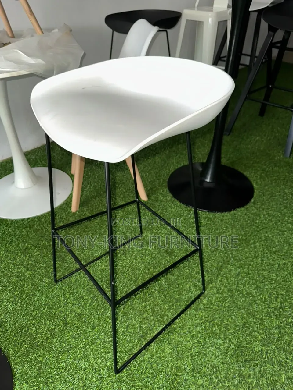 Modern White Bar Stool Features a Curved Fiber Seat and a Minimalist