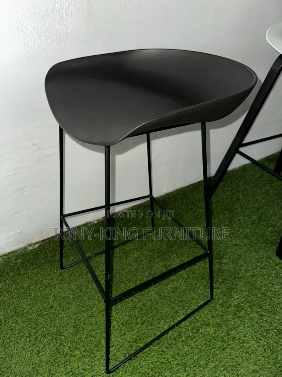Modern White Bar Stool Features a Curved Fiber Seat and a Minimalist