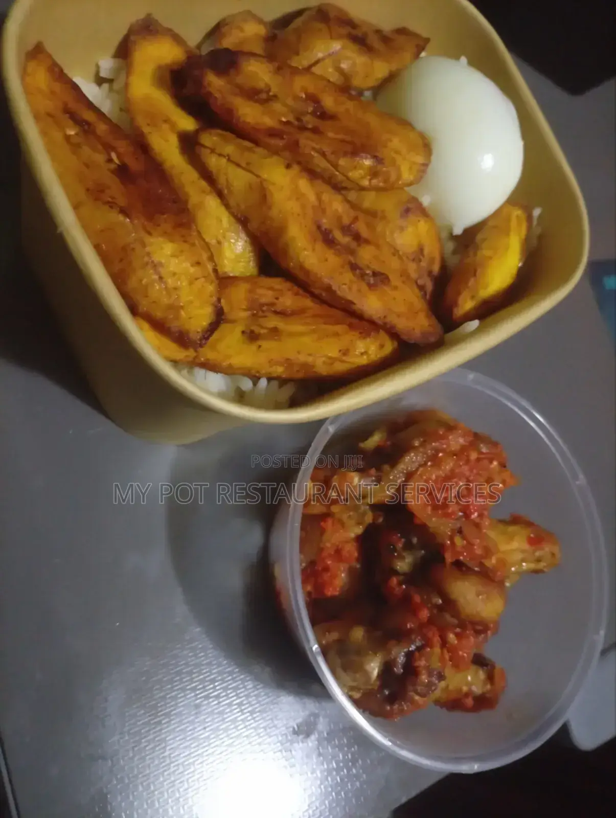 Pack of White Rice Chicken Wings Plantain Egg and Stew