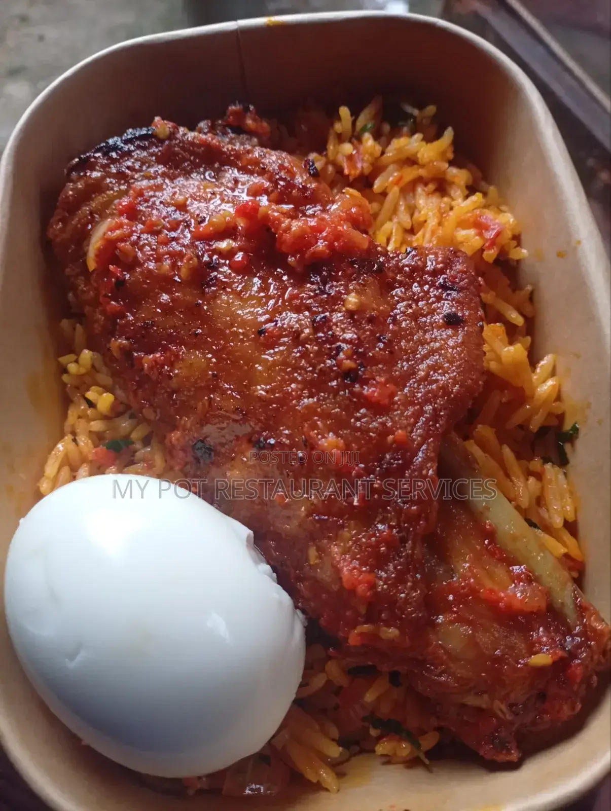 A Pack of Native Jollof Rice With Turkey