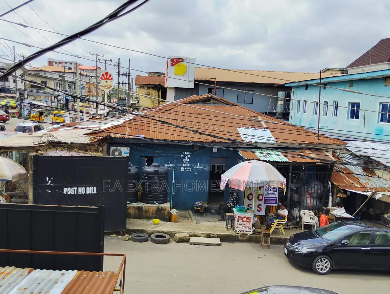 A Bungalow, Consist of Rooms and (8 Units) of Shops, on a Corner Piece