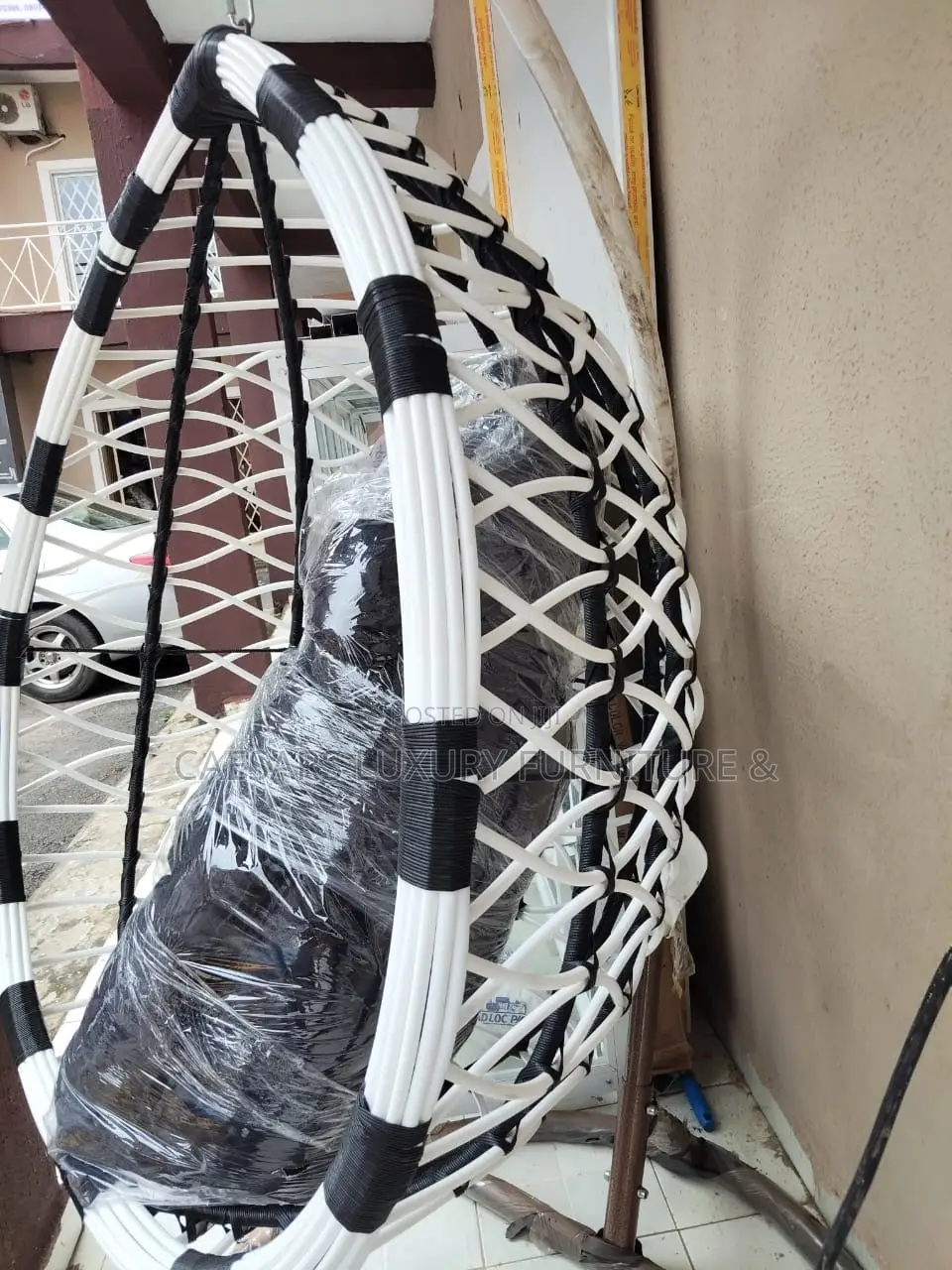 White and Black Hanging Swing Chair With Stand