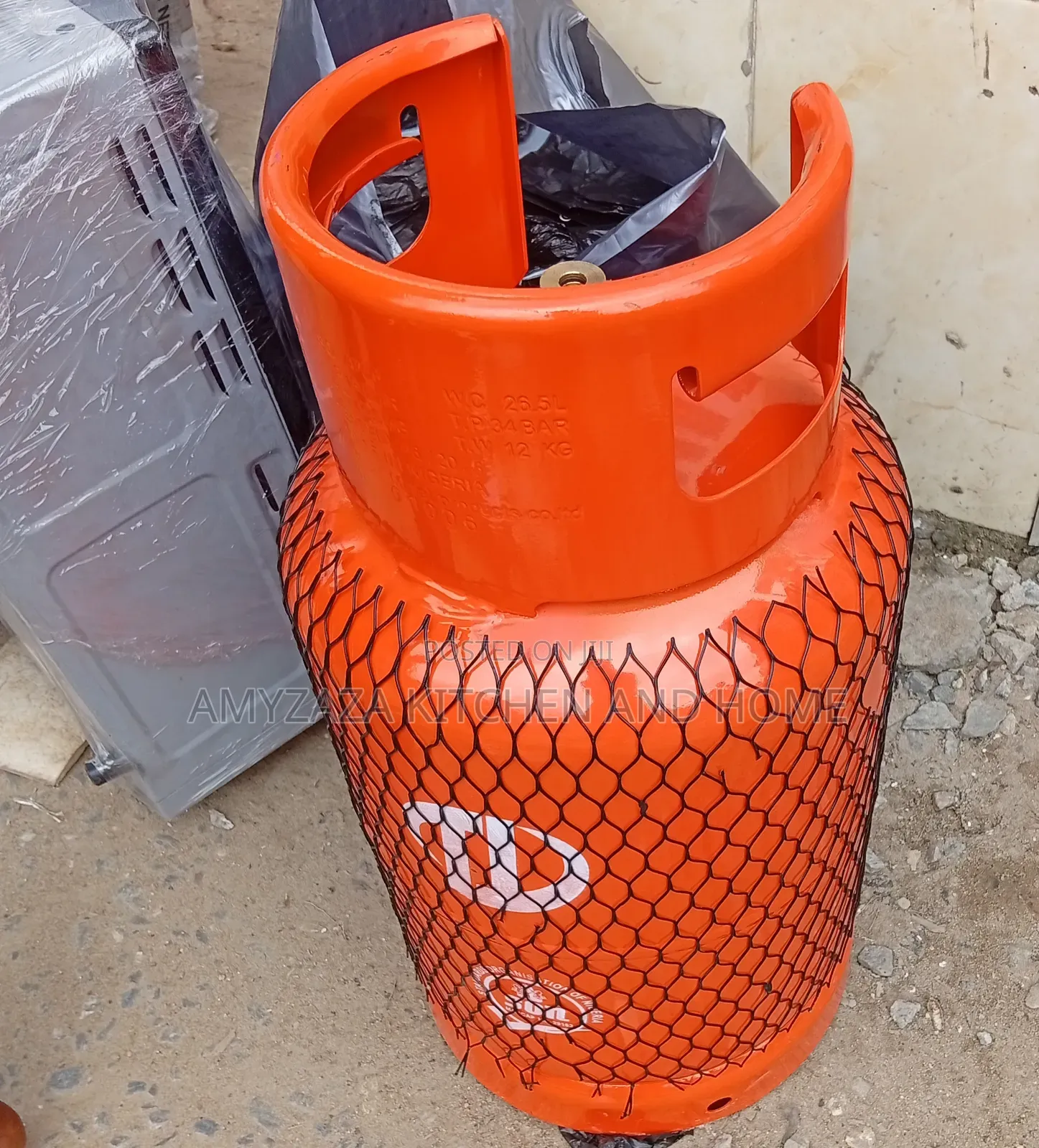 12.5 Kg LPG Cooking Gas Cylinder Wrapped in a Protective Mesh Net.