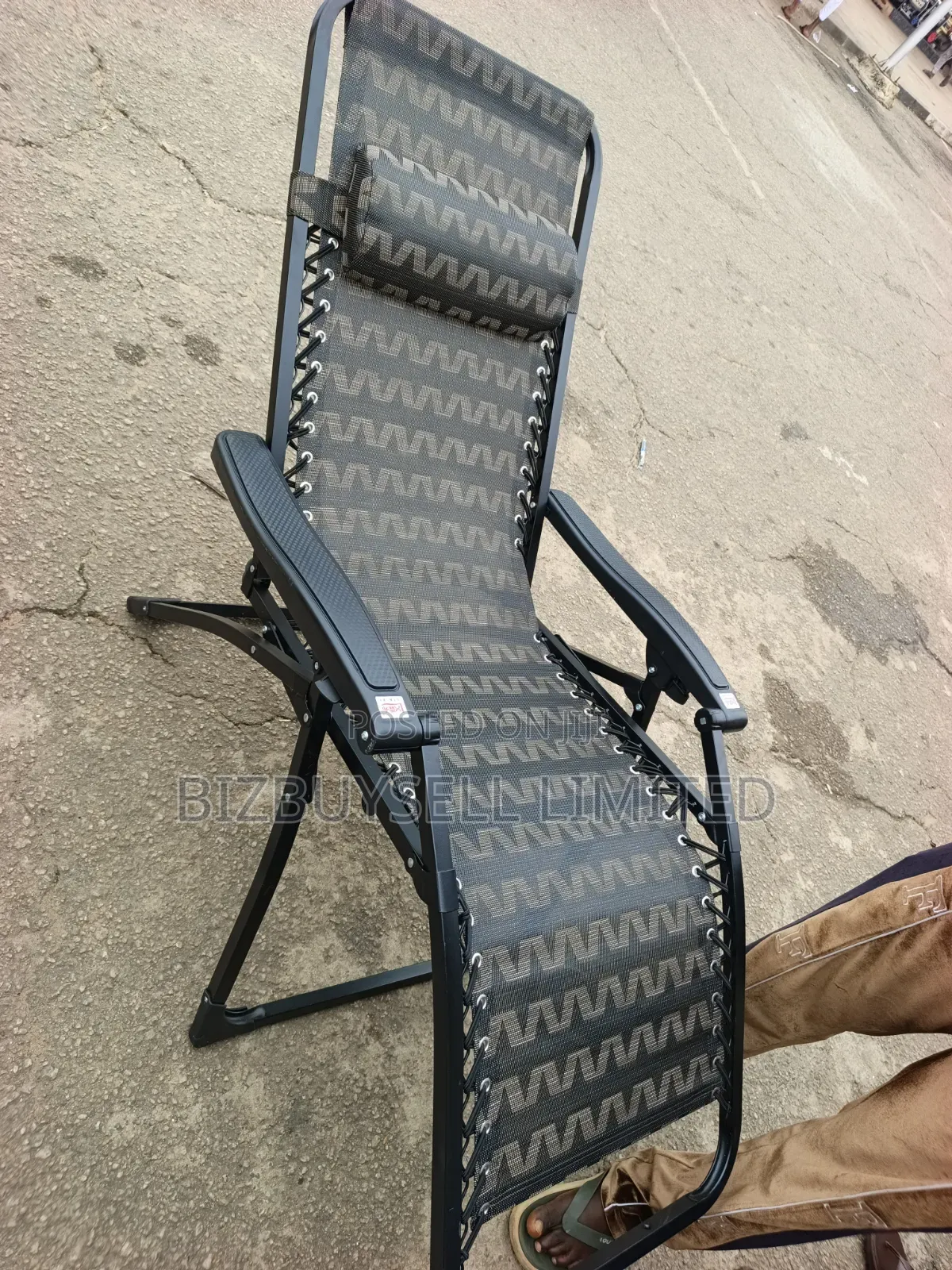 Folding Outdoor Relaxing Lounge Chair With a Patterned Mesh Fabric.