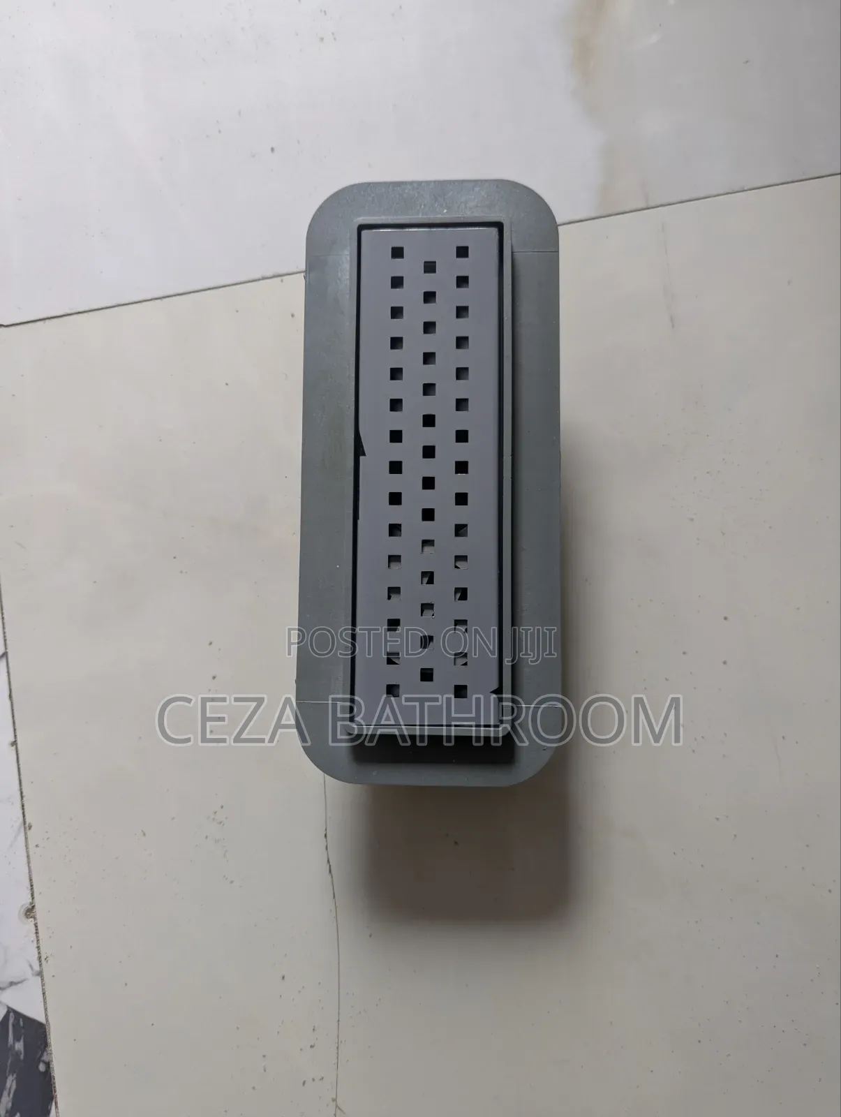 Floor Drain or Shower Channel Drain With a Slotted Rectangular Grate