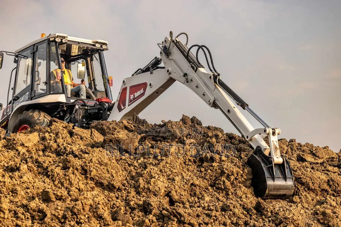 Bobcat B760 Backhoe Loader Digging Into a Mound of Earth