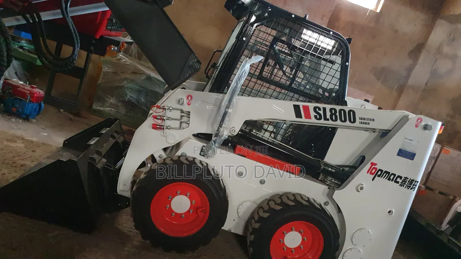 Bobcat B760 Backhoe Loader Digging Into a Mound of Earth
