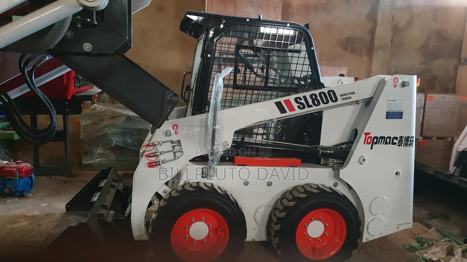 Bobcat B760 Backhoe Loader Digging Into a Mound of Earth