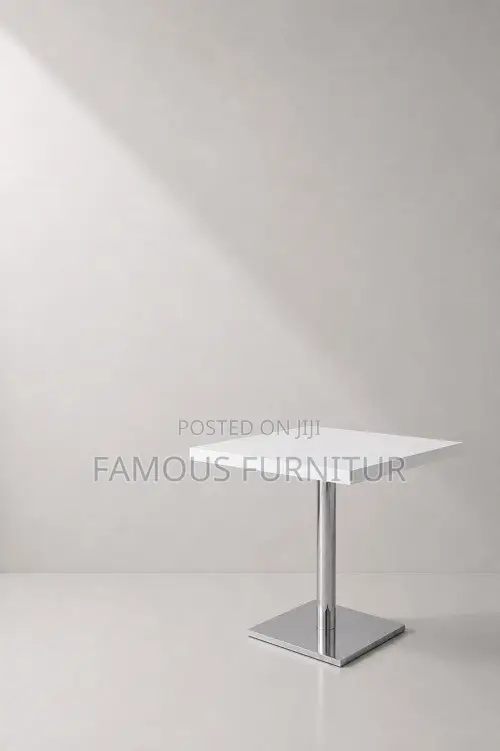 Modern Round Pedestal Restaurant Table With a White Top Square Base.