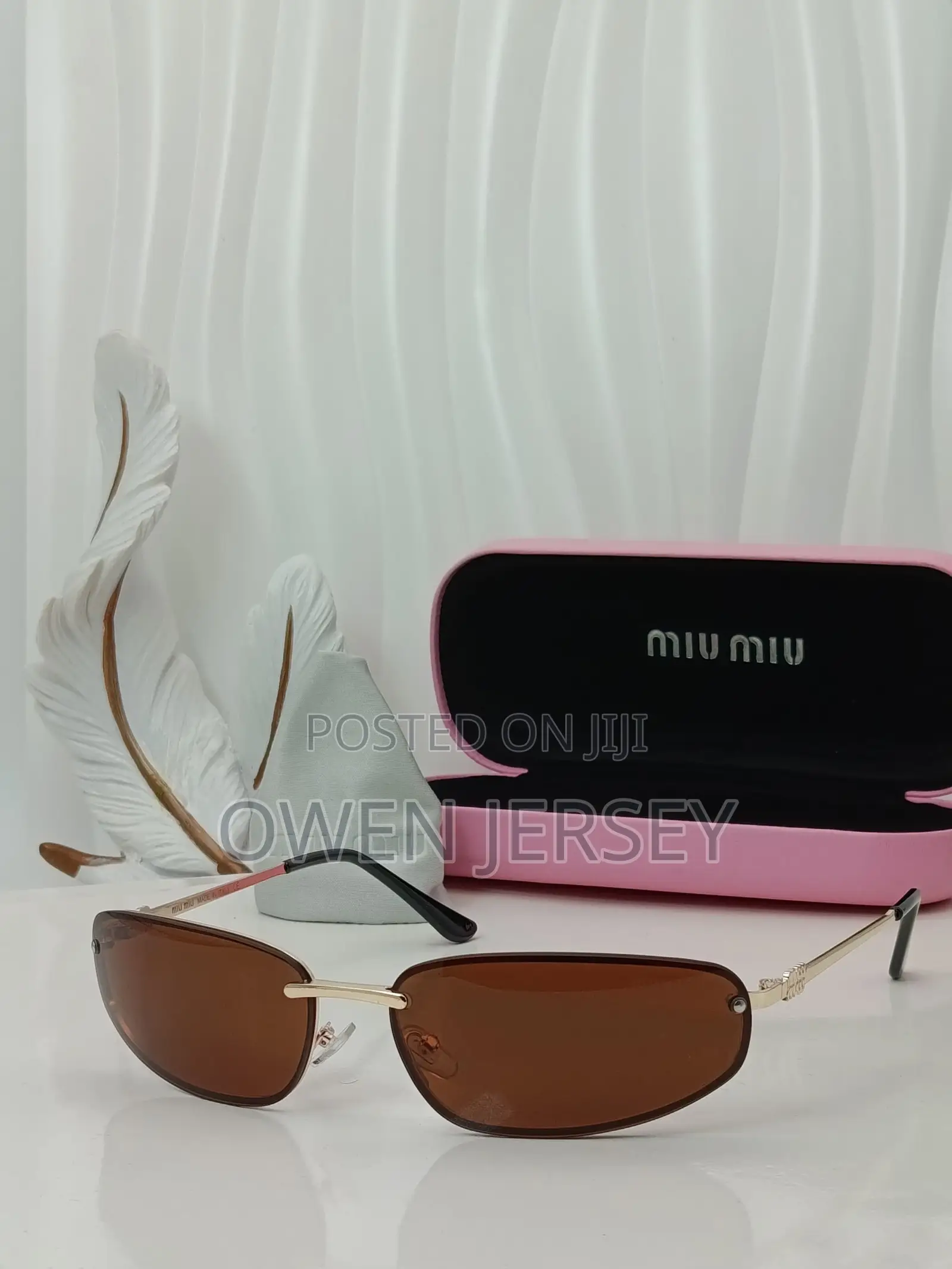 Miu Miu Rimless Cat-Eye Sunglasses With Gold Accents.