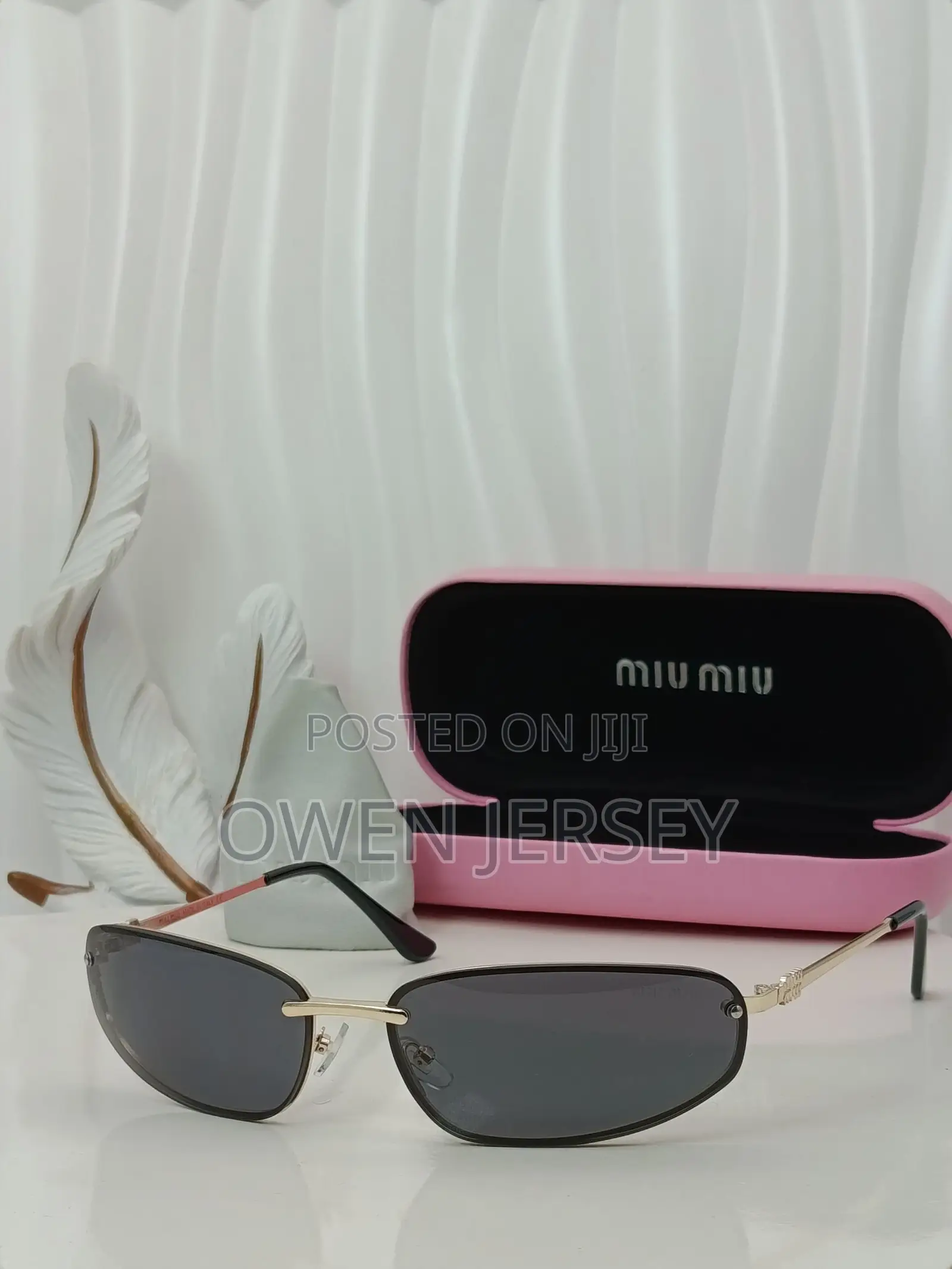 Miu Miu Rimless Cat-Eye Sunglasses With Gold Accents.