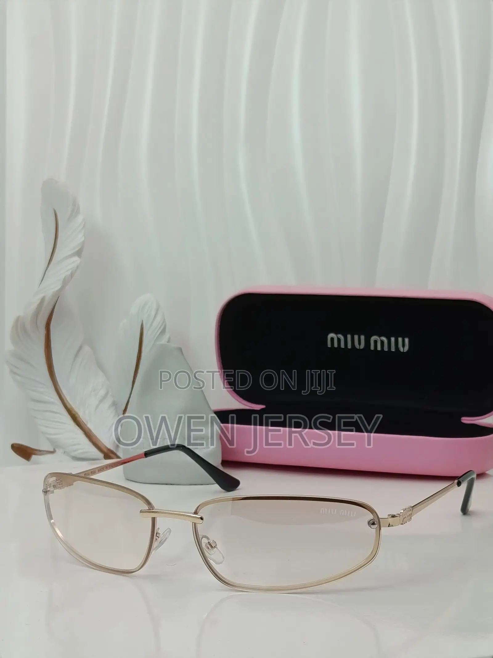 Miu Miu Rimless Cat-Eye Sunglasses With Gold Accents.