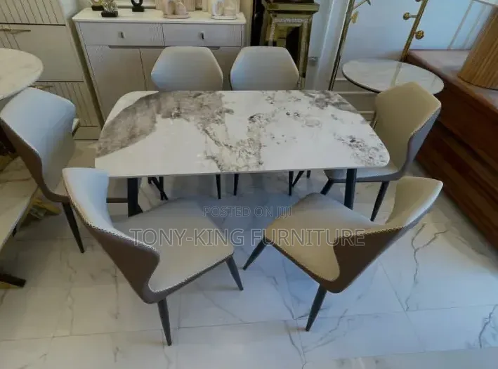 A Modern 6-Seater Marble Top Dining Set With Six Cushioned Chairs