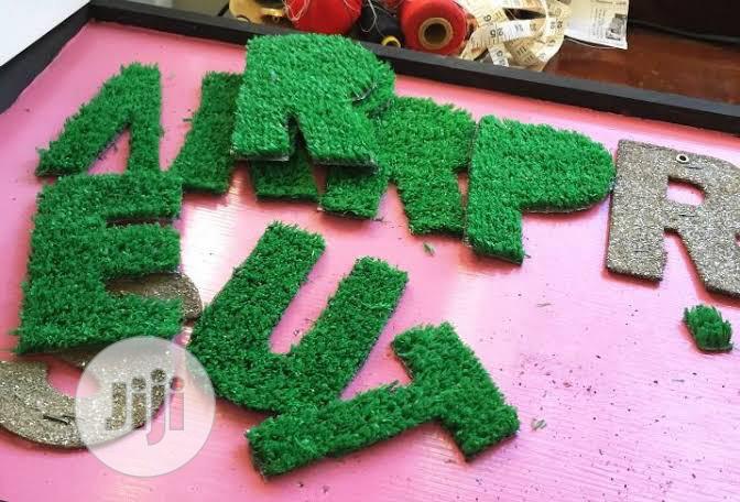 We Create Alphabet With Green Grass Rugs