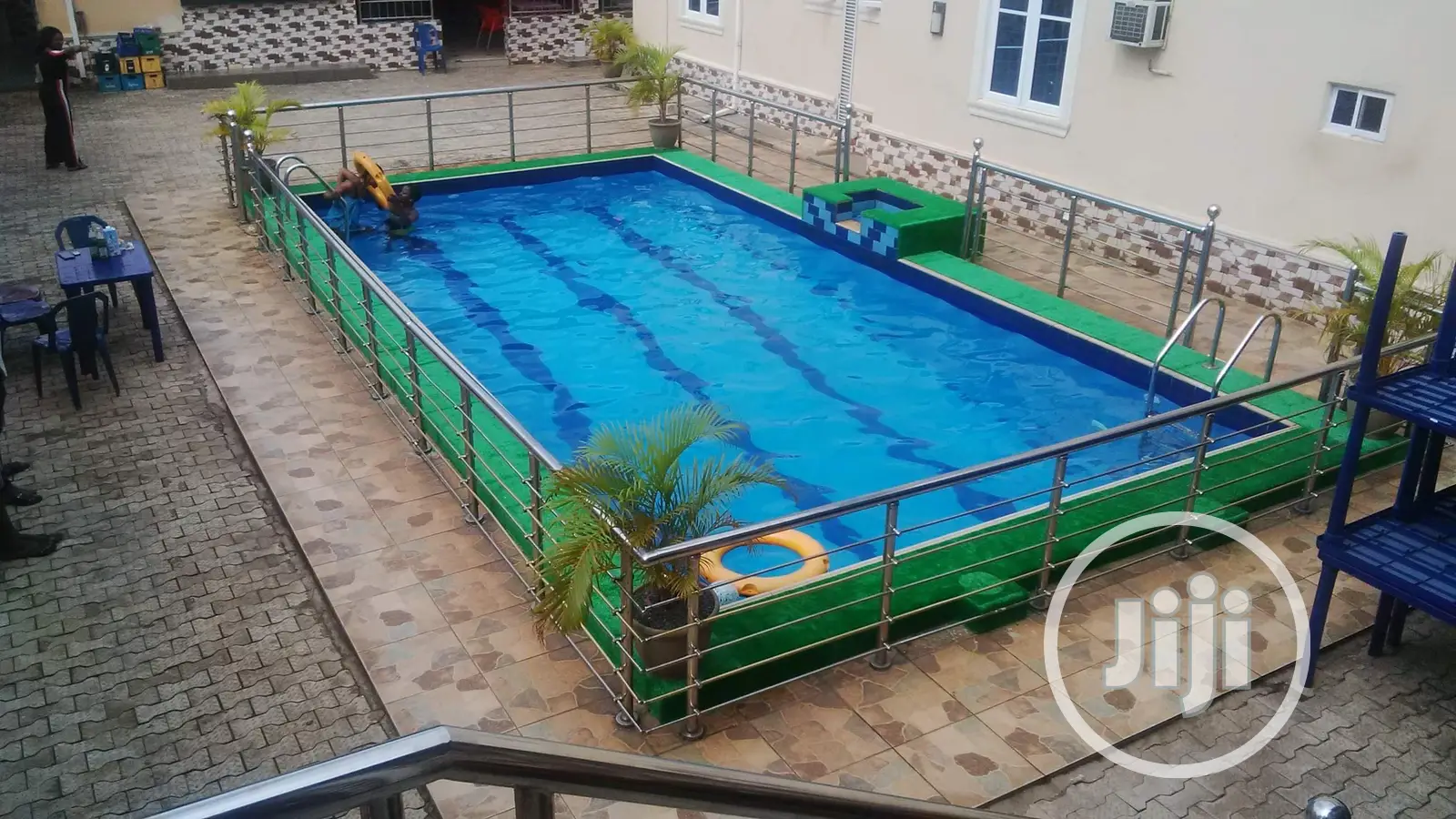Redefined Your Pool Surrounding With Green Grass Rugs