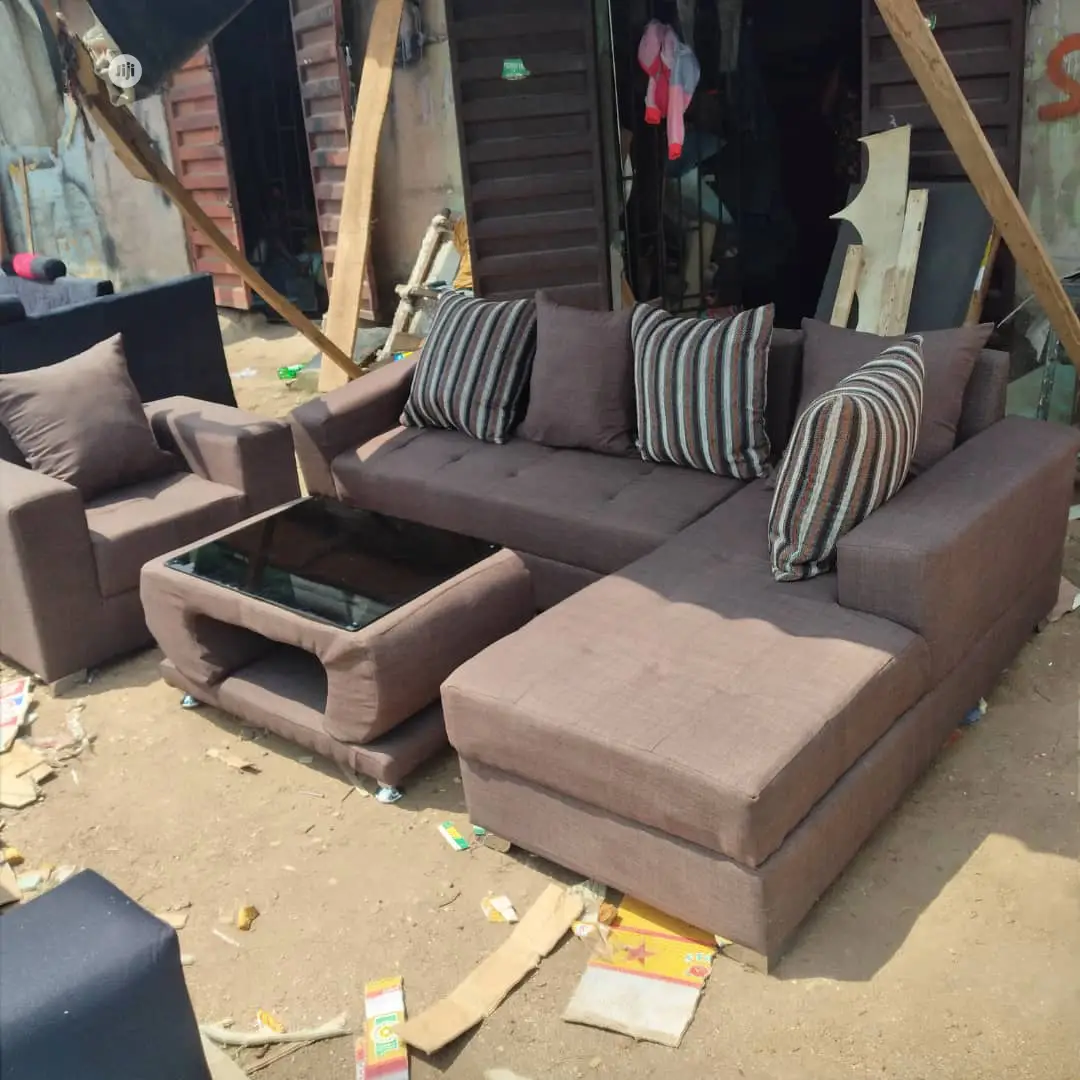 Brown L- Shaped Sofa With One Single and Center Table
