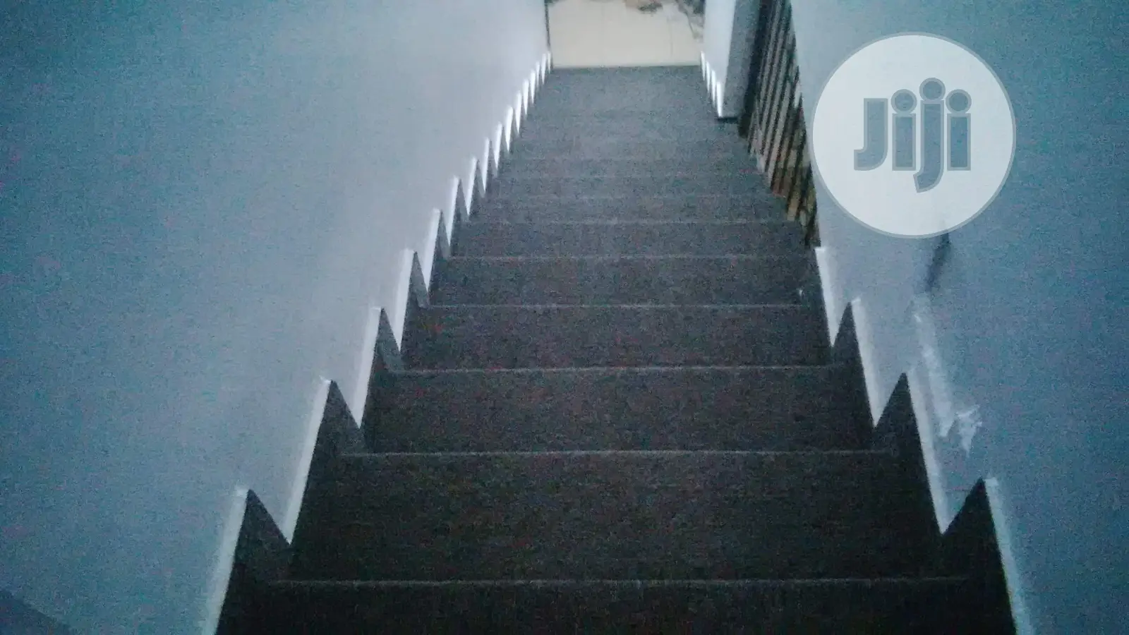 Transformation of Rough Staircase With Smooth Grey Rug